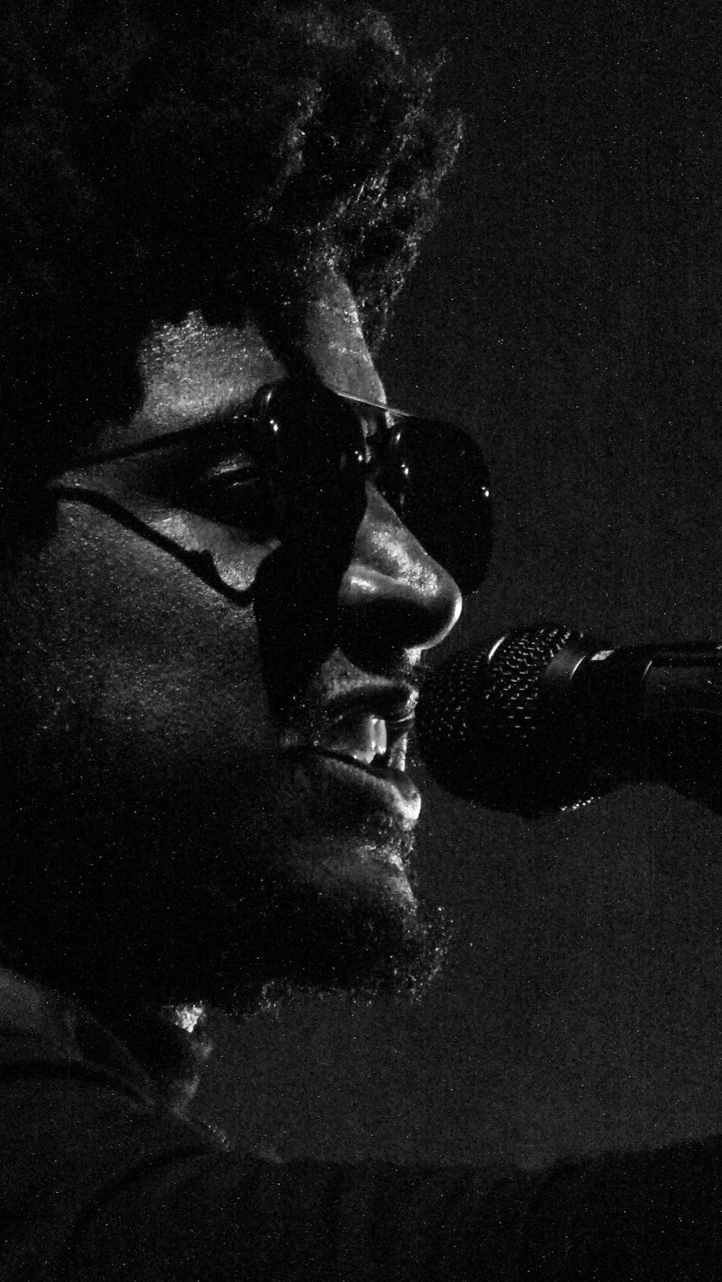 Labrinth performing in silhouette against a lit stage screen