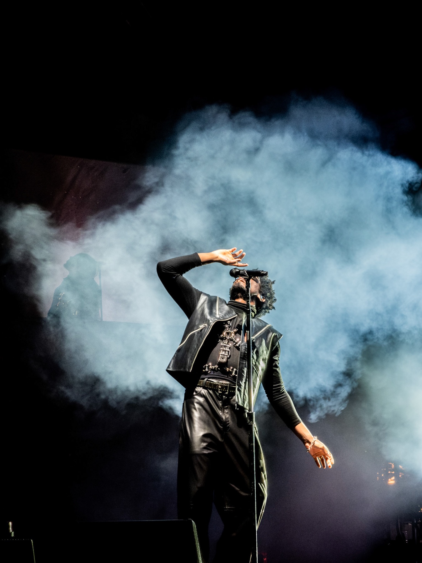 Labrinth performing in silhouette against a lit stage screen