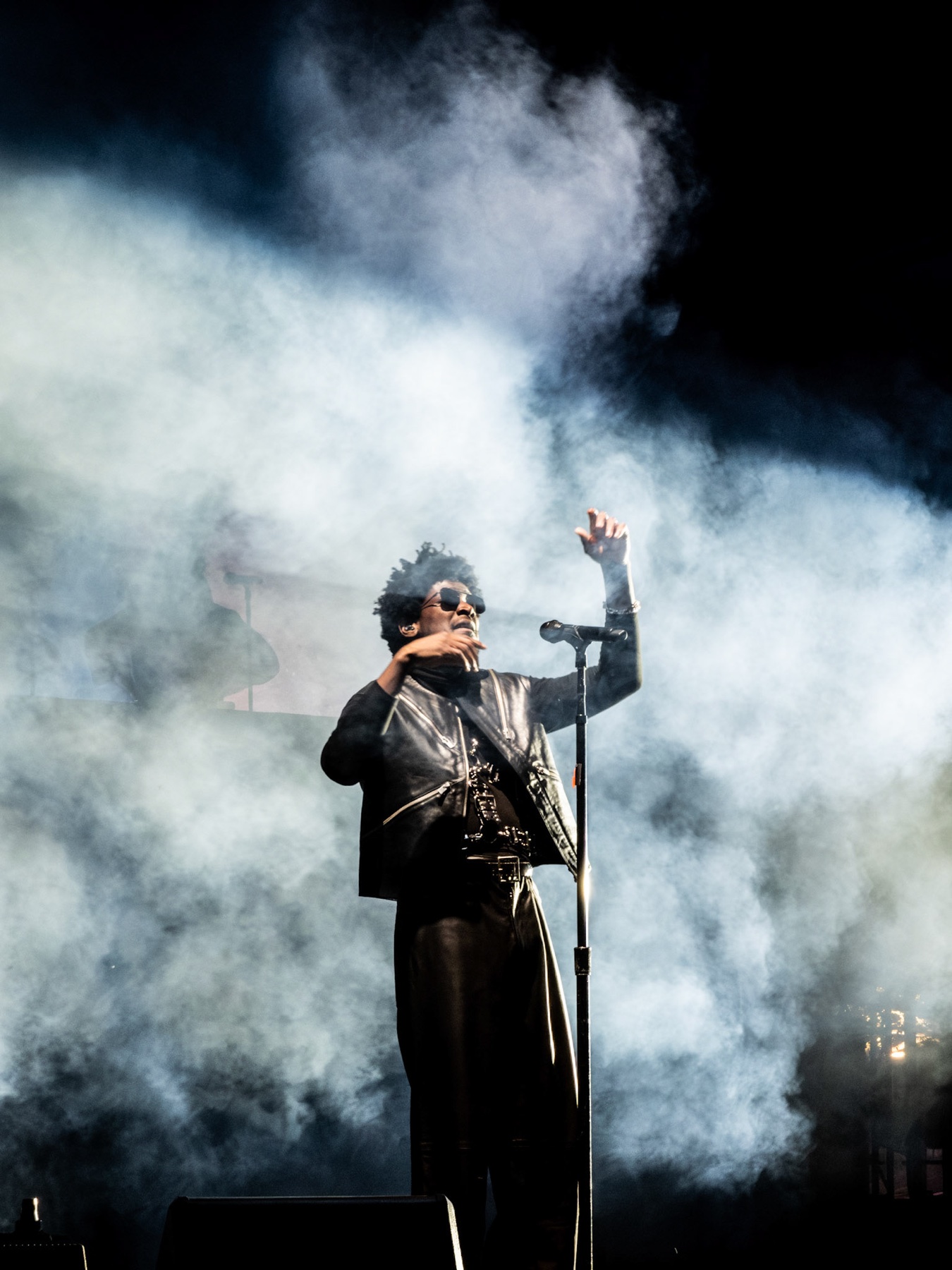 Labrinth performing in silhouette against a lit stage screen