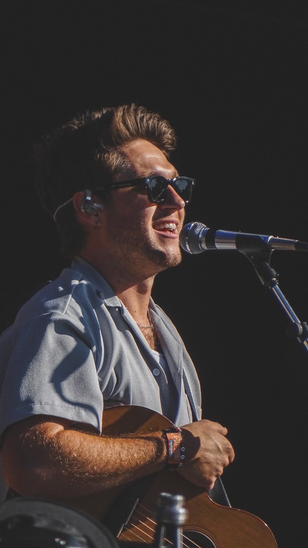 Niall Horan performing live with a guitar