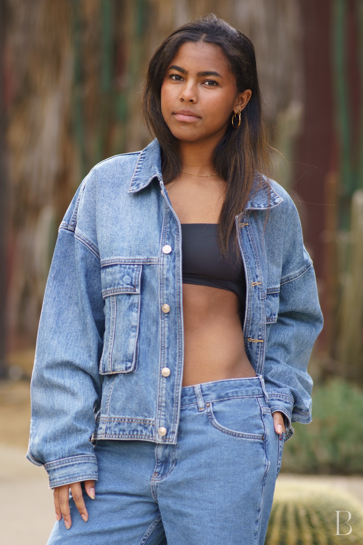 Model in double denim against desert planting